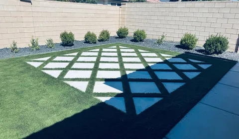 Residential lawn with healthy artificial turf after professional cleaning